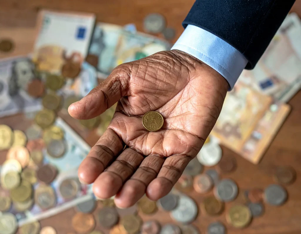 Monederia Cuenca- moneda sostenida por un adulto mayor